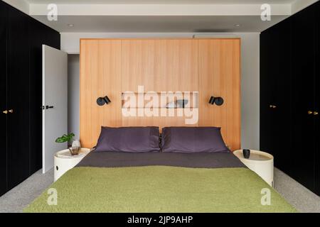 Master bedroom with floating wardrobe and bedhead. Birchgrove House, Sydney, Australia. Architect: TW Architects, 2021. Stock Photo