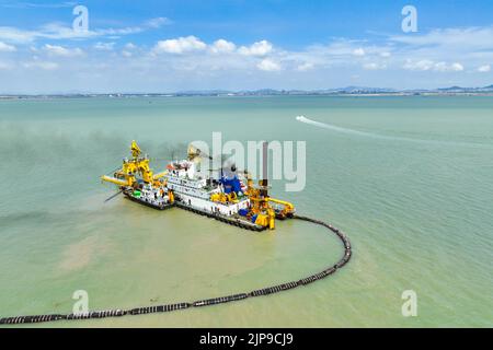 LIANYUNGANG, CHINA - AUGUST 16, 2022 - A large cutter suction dredger carries out dredging and filling construction work at Ganyu Port area of Lianyun Stock Photo