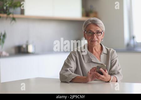 mature woman calling on the phone in the office Stock Photo