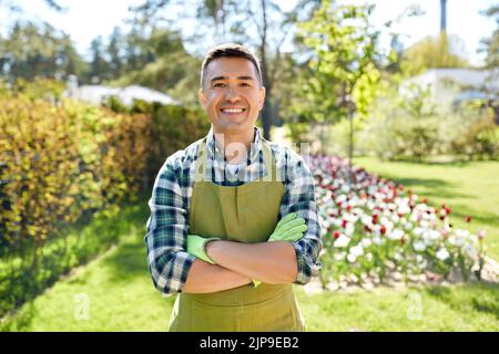 happy man in apron at summer garden Stock Photo