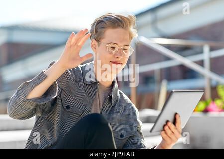 teenage boy with tablet computer having video call Stock Photo