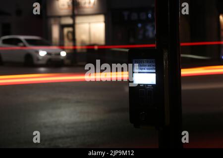 Prestwick Cross, Main Street, Prestwick, Ayrshire, Scotland, UK. Night time photos showing Pelican crossing with light trails. Close up of push button Stock Photo