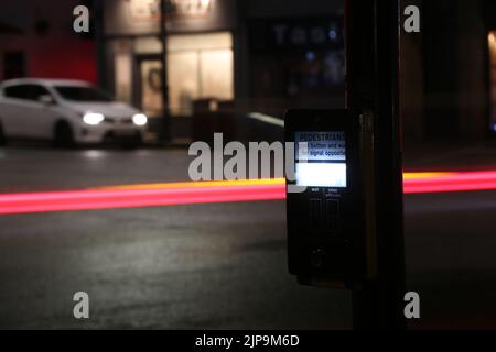 Prestwick Cross, Main Street, Prestwick, Ayrshire, Scotland, UK. Night time photos showing Pelican crossing with light trails. Close up of push button Stock Photo