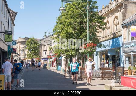 People walking through Buxton town centre, Derbyshire, England, UK Stock Photo