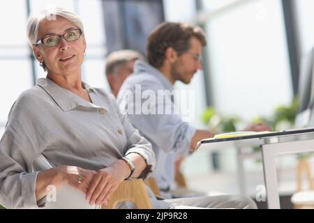 60 year old business woman in a work environment Stock Photo