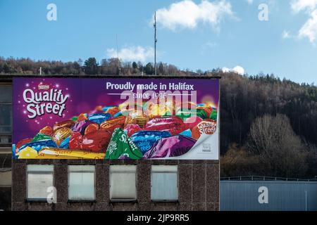 UK confectioners, Quality Street advert - Proudly made in Halifax since 1926 at Halifax railway station, West Yorkshire, England. Stock Photo
