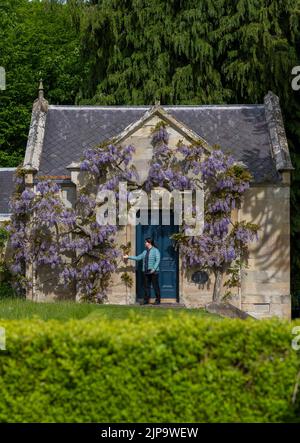 Floors Castle Gardens, Kelso, Scottish Borders. Joan Milner takes a few moments out of her day while at Floors Castle gardens near Kelso in the Scotti Stock Photo
