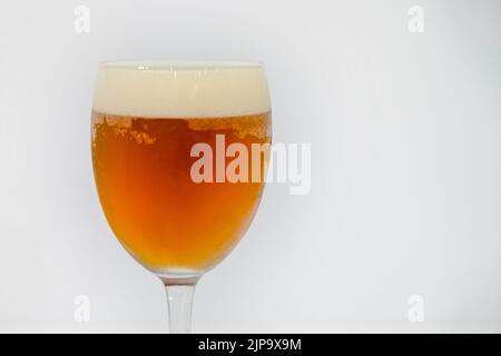 Ice cold beer glass on red background. Stock Photo