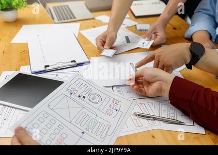 UX UI Concept, Graphic designers work together with UX UI designer planning application template layout framework for mobile phone computer mobile Stock Photo