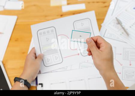 UX UI Concept, Graphic designers work together with UX UI designer planning application template layout framework for mobile phone computer mobile Stock Photo