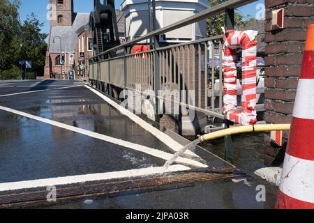 Cold water from hose cools the movable parts of a drawbridge to prevent ...