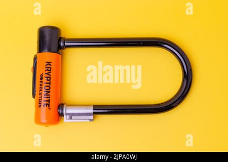 A kryptonite black U-Lock isolated on a yellow background Stock Photo