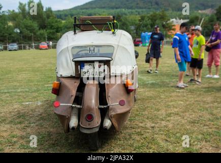 Rear View of Original Classic Brown Three Wheeled Leather Cloth Velorex Car with a Roof Rack at Oldtimer Classic Car Meeting Stock Photo