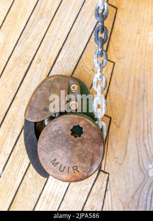 Old Muir vertical anchor windlass on a sail boat Stock Photo