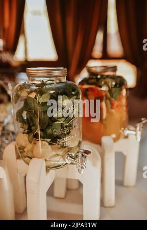 Catering. Drinks on wedding party. Cocktail glasses full of red alcohol stand on table. Beautiful row line of different colored alcohol cocktails with Stock Photo