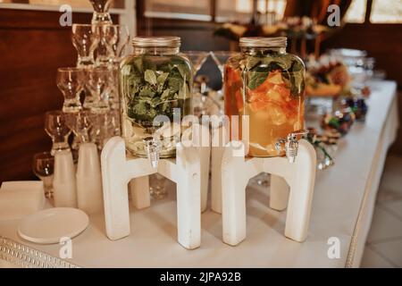Catering. Drinks on wedding party. Cocktail glasses full of red alcohol stand on table. Beautiful row line of different colored alcohol cocktails with Stock Photo
