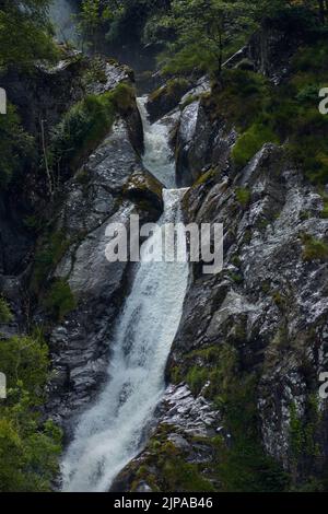 Photograph of Aber falls waterfall, Snowdonia National Park, North Wales.  Shown is a section near the top of the falls taken from the bottom. Stock Photo