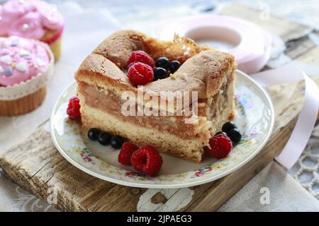 Apple pie decorated with raspberries and blueberries. Birthday party table. Stock Photo