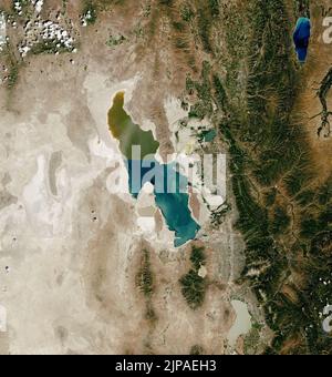 Utah, USA. 12th Aug, 2022. FILE: July 2022. Few other lakes in the United States rival the Great Salt Lake in size and significance. It is the largest saline lake in the country and the eighth-largest in the world (by area). Home to extensive brine shrimp and salt harvesting operations, magnesium mining, and recreational activities, the lake contributes an estimated $1.5 billion to Utah's economy. Its shallow waters also sustain millions of migratory birds. Yet for most of the past four decades, water levels have been falling and the surface area has been shrinking. The Landsat image above, Stock Photo