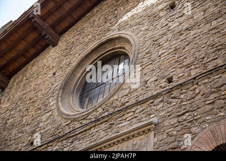 Large vintage round window with bars. Decorative element of an old renaissance building in Italy. Stock Photo