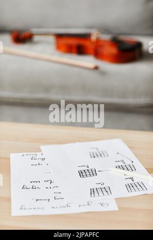 Vertical background image of music composition sheets on table in home interior, copy space Stock Photo