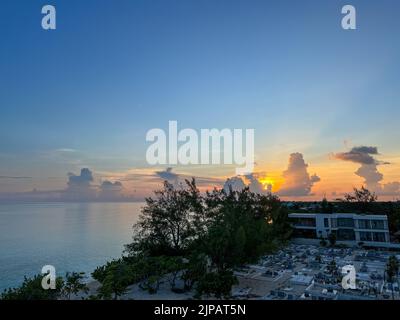 An aerial view of Cemetery Beach on Seven Mile Beach in Grand Cayman Island with a beautiful sunset. Stock Photo