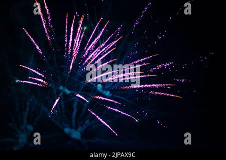 An explosion of bright single fireworks, against the background of the night sky. High quality photo Stock Photo