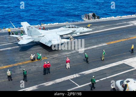 Philippine Sea, United States. 14 August, 2022. A U.S. Navy F/A-18F Super Hornet, attached to the Diamondbacks of Strike Fighter Squadron 102, is given the go for take off from the flight deck of the Nimitz-class aircraft carrier USS Ronald Reagan underway, August 14, 2022 operating on the Philippine Sea. Credit: MC3 Eric Stanton/U.S. Navy/Alamy Live News Stock Photo