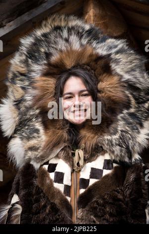 An Athabaskan Girl poses in native costume at the Chena Indian Village in Fairbanks, Alaska Stock Photo