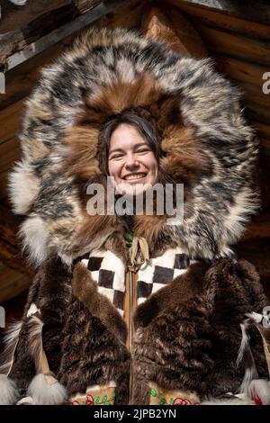 An Athabaskan Girl poses in native costume at the Chena Indian Village in Fairbanks, Alaska Stock Photo