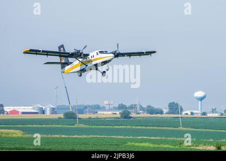 The U.S. Army Parachute Team jump aircraft, the UV-18 Viking Twin Otter, takes flight n Ottawa, Illinois on 16 August, 2022.  The U.S. Army Parachute Team is in town conducting tandems ahead of the Chicago Air and Water Show on 20-21 August. (U.S. Army photo by Megan Hackett) Stock Photo