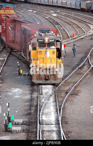 Railroad train yard with sidings and switchers and engines and cars and repair facilities in Utah Stock Photo