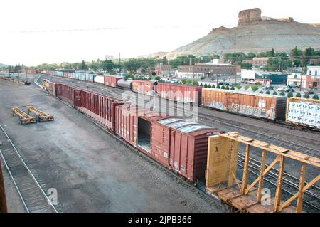 Railroad train yard with sidings and switchers and engines and cars and repair facilities in Utah Stock Photo