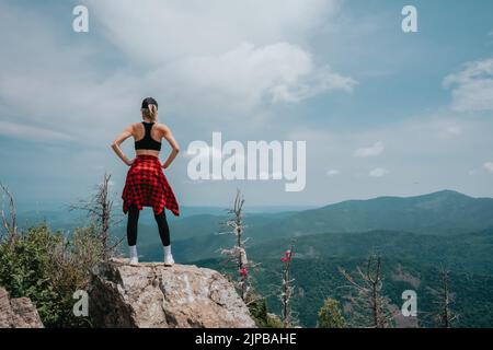 A girl on top of Falaza mountain looks at a beautiful mountain valley. Travel and tourism. Hiking High quality photo Stock Photo