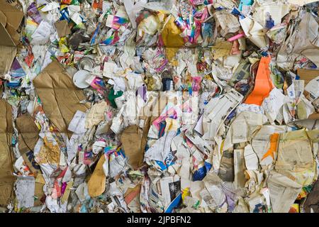 Tied bale of recyclable cardboard and paper at a sorting centre. Stock Photo