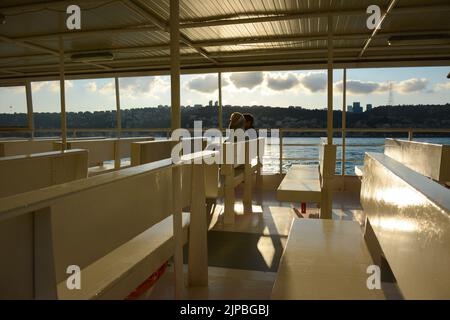 sunshine spread on the ferry boat and lovers sitting on the chair Stock Photo