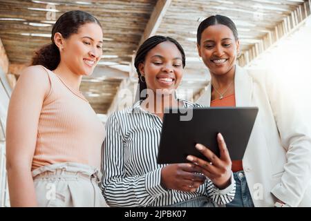 Startup entrepreneur, small business owner and business woman working together as a a team on a tablet from below. Discussing ui and ix ideas while at Stock Photo