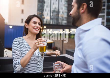 Getting to know our colleagues over drinks. businesspeople having drinks on their office balcony. Stock Photo