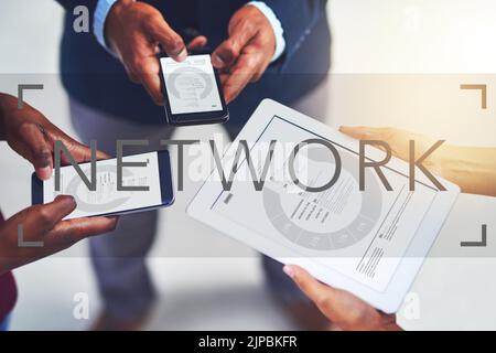 Stay connected to your business network. a group of businesspeople using wireless devices during a collaboration. Stock Photo