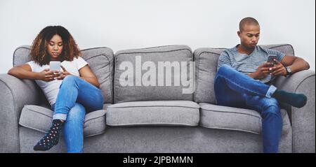 Arguments are never nice. a young couple sitting on the sofa after an argument. Stock Photo