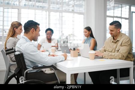 Team analyzes research discussing and marketing data while planning strategy in startup agency. Group of diverse business people sharing ideas Stock Photo