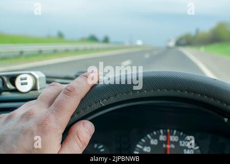 view of a man hand on the steering wheel of a car Stock Photo