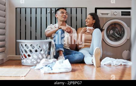 Couple, chores and laundry while doing home cleaning and feeling happy while talking and relaxing together. Boyfriend and girlfriend with healthy Stock Photo