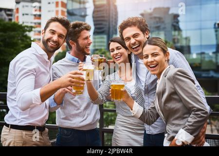 Hard workers deserve a break. businesspeople having drinks on their office balcony. Stock Photo