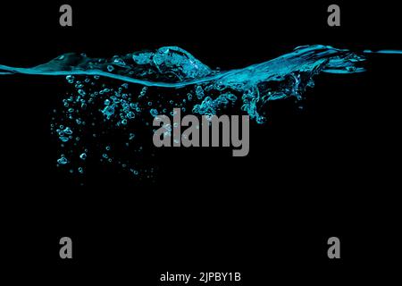 Clear water surface with ripple and bubbles in blue light on a black nature background Stock Photo