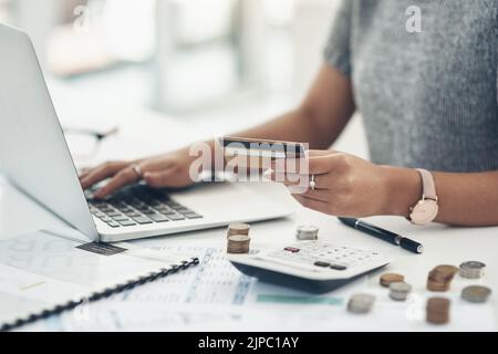 Budget with technology for online shopping and working indoors. Closeup of financial advisor counting money on laptop in the office. Businesswoman Stock Photo