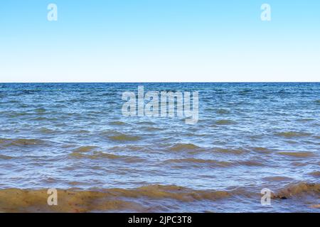 Small ocean waves on the sea, horizon and blue sky, nature and environment background, copy space, selected focus Stock Photo