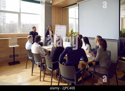 Business meeting office employees of modern corporation in conference room with manager or CEO Stock Photo
