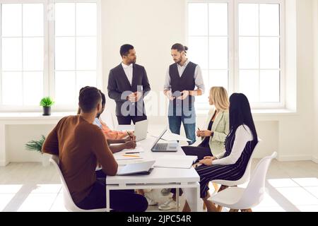 Young diverse business team having discussion during corporate meeting in office Stock Photo