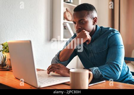 Man thinking, typing and working on a laptop remote for a social media startup content writing business. Planning, focused and serious freelancer Stock Photo